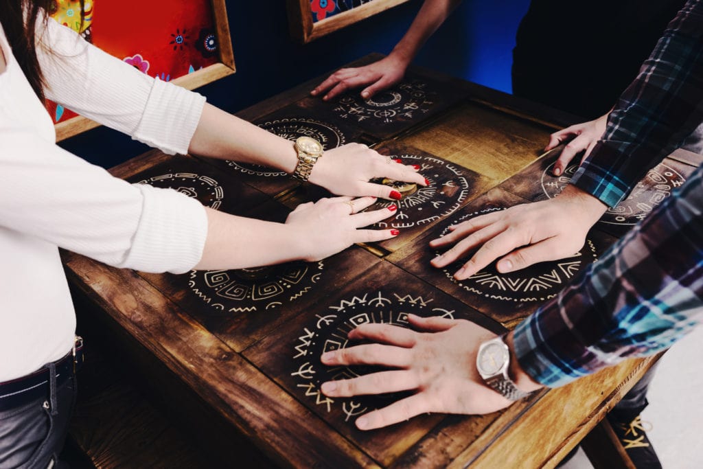 people solving puzzle | 5 Fun Facts About Escape Rooms: July Edition